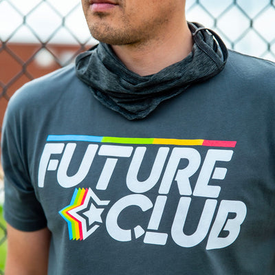 Close up image of a man wearing the Future Club shirt with a blurred background.