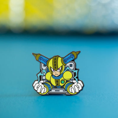 A closeup photo of the Fuse Man pin on a blue platform, with a shiny metallic backdrop behind him.