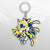 Image featuring a cutout of keychain number 12 from the Blazblue merchandise collection, set against a pixelated background.