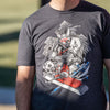 The photo shows a closeup shot of a man wearing the Guilty Gear Strive tee shirt. The man is standing in shadows, but there is a beam of sunlight that is hitting the design just right to brighten it up.
