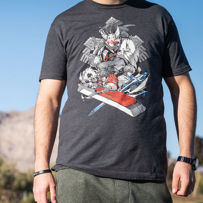 A closeup photo of a man wearing the Guilty Gear Strive shirt. There are nice blurred mountains in the background.