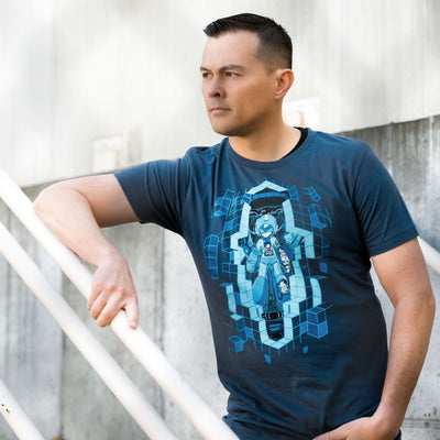 This photo shows a young man wearing the Mega Man Upgrade shirt. He is leaning on a stair railing, the foreground has a chain link fence that is nicely blurred to add some depth.