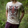 An image of a young man wearing the Monster Hunter Odogaron shirt. He is standing in a forest with a nicely blurred background.