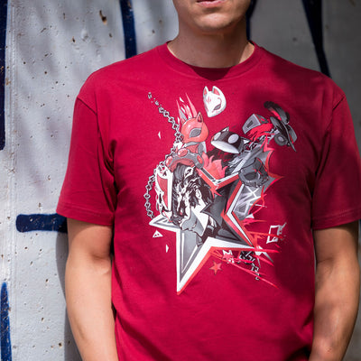 Photograph of a man wearing the Persona 5 Masks tee. He is standing in front of a cement wall with graffiti on it.