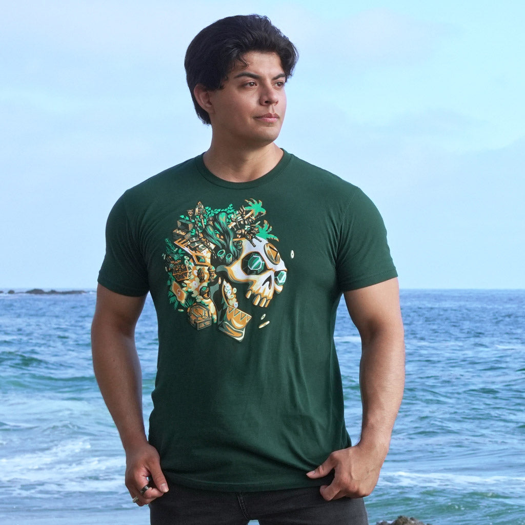 Man at the beach wearing the Sea of Thieves Gold Hoarder T-Shirt with the ocean as a backdrop.
