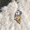 The Shin Megami Tensei V Jack Royal Cone pin sits upon a bed of white fluffy snow.