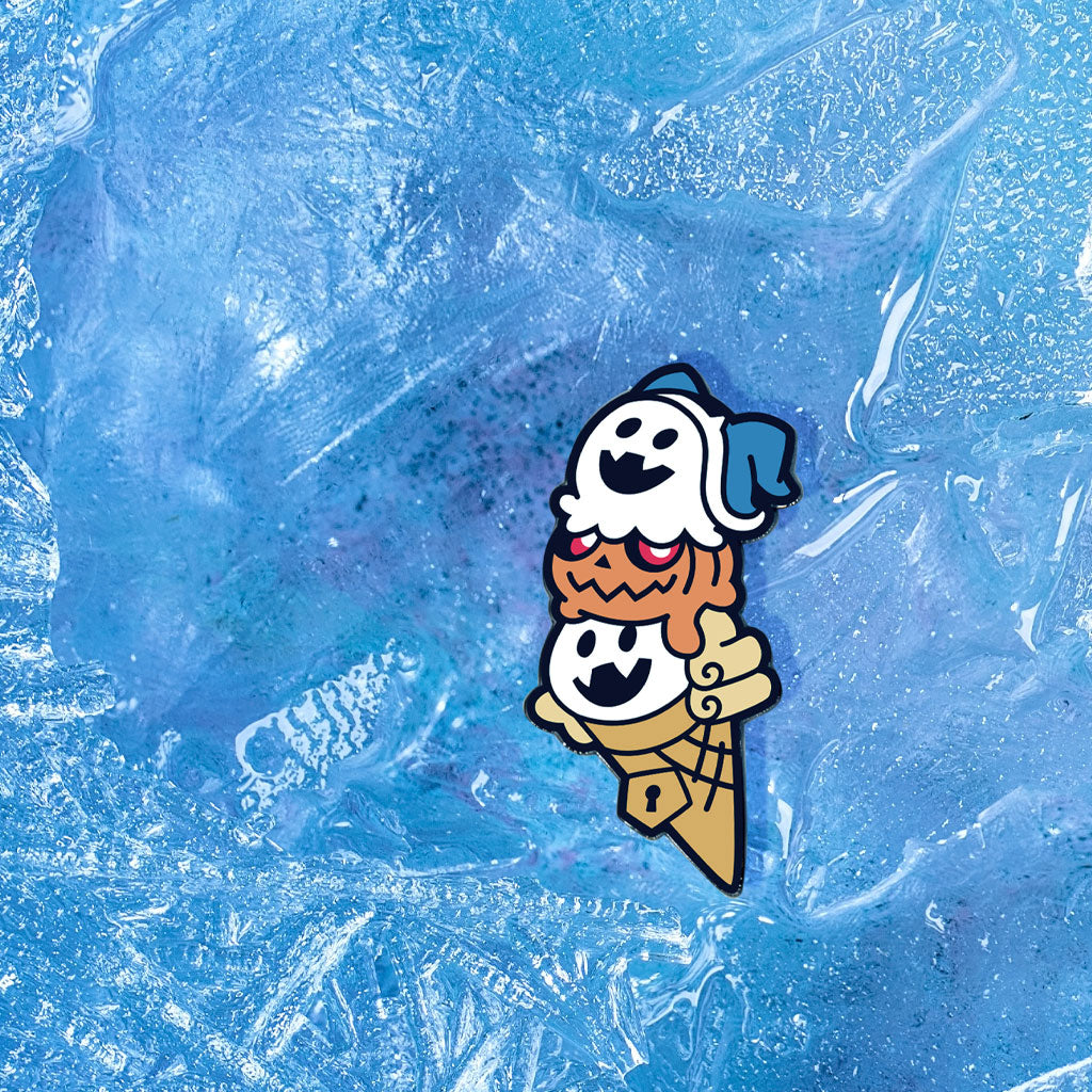 The Shin Megami Tensei V Jack Royal Cone pin sits upon a bed of white fluffy snow.