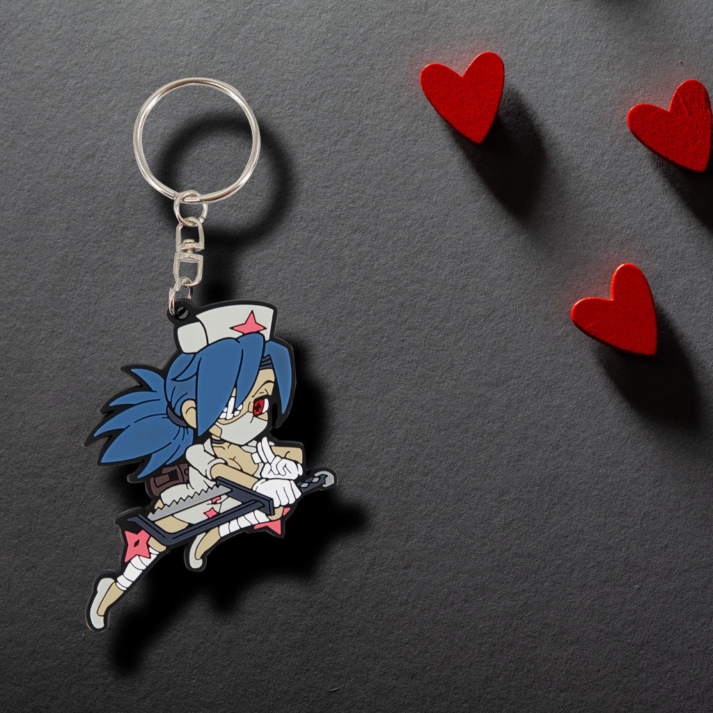 Skullgirls Valentine Keychain shown on a table with floating red hearts with deep drop shadows.