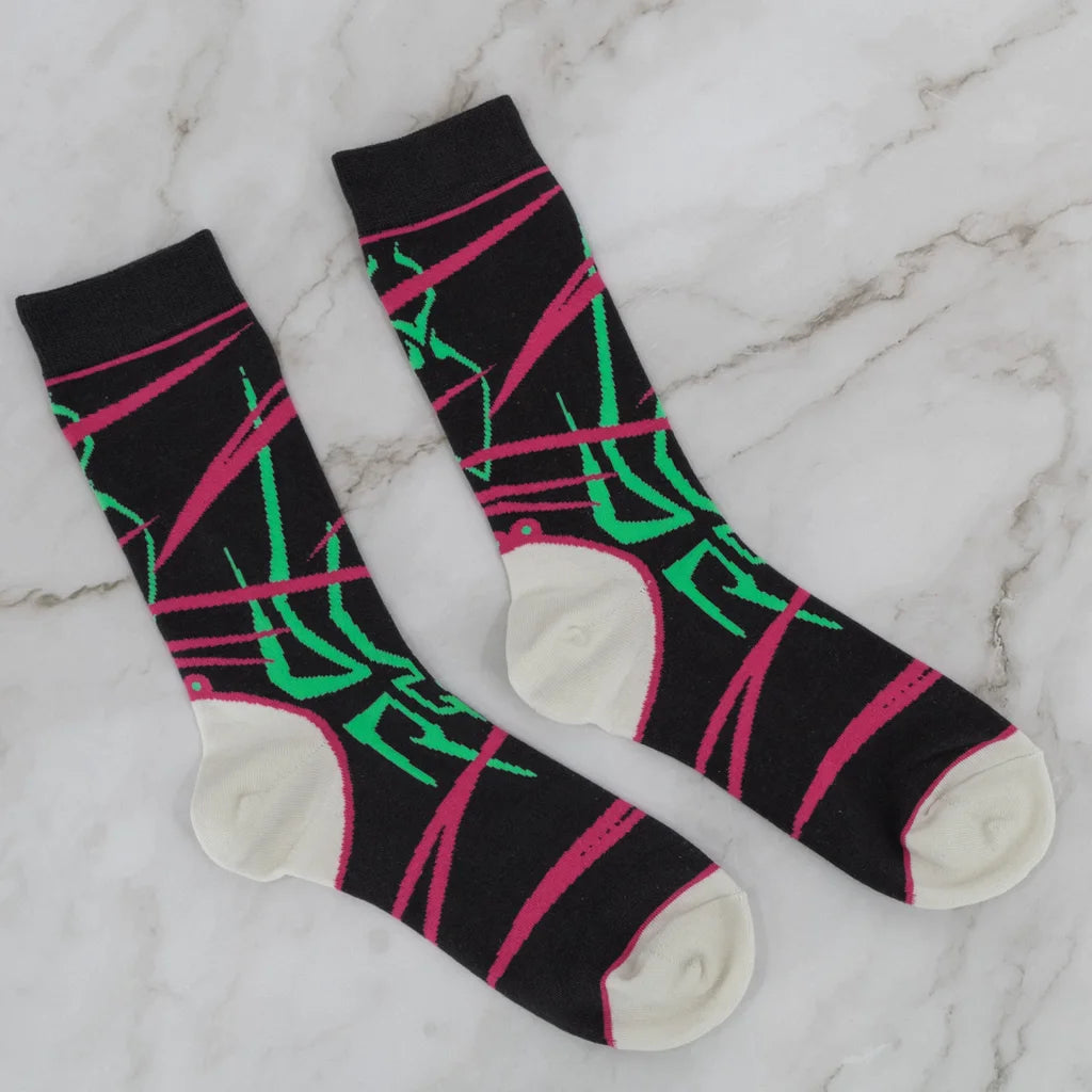 Juri Street Fighter socks flat lay, black with pink and green design, cream heel and toe