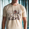 A close up photo of a man wearing the Street Fighter Chest Slap tee. It has a nice blurred background of pillars with water.