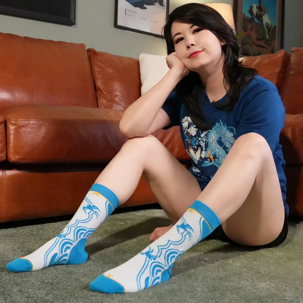 Person in blue Chun-Li t-shirt and matching Chun-Li Street Fighter 6 socks