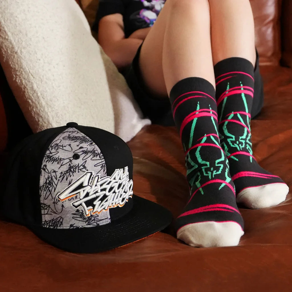 Juri Street Fighter socks worn on couch with Street Fighter Signature snapback