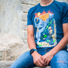 A photo of a man sitting on a stone structure wearing the Street Fighter King's Court shirt. It has a nice blurred background of the stone colored structure.