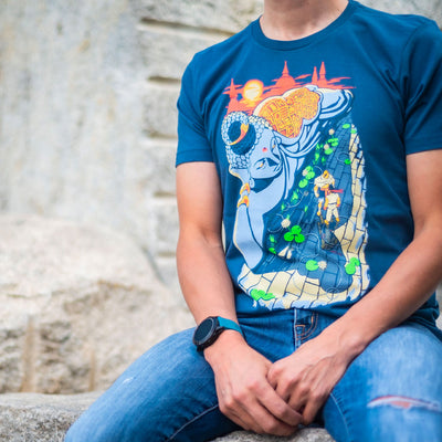 A photo of a man sitting on a stone structure wearing the Street Fighter King's Court shirt. It has a nice blurred background of the stone colored structure.