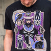 Close up photo of a man wearing the Street Fighter Menat tee. It shows the crisp artwork on the black tee with great detail depicting the character.