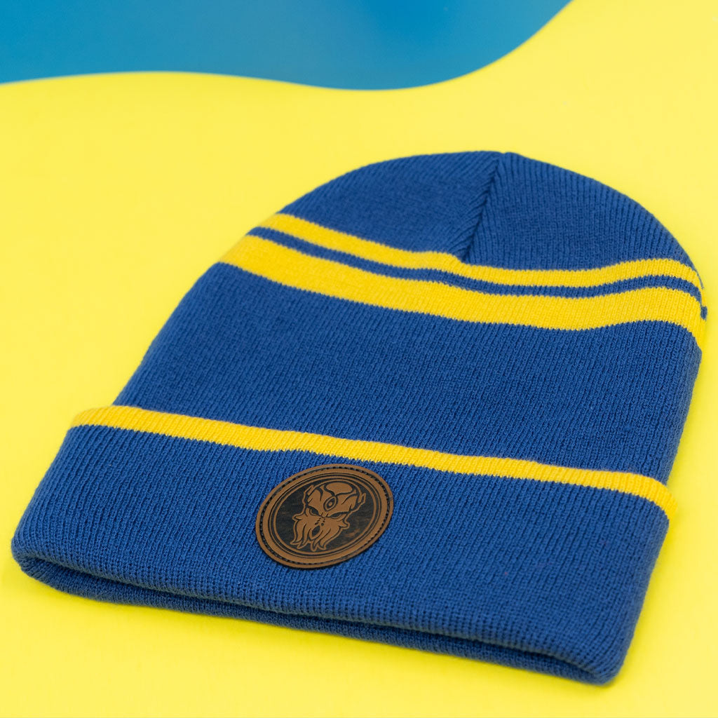 Detailed flatlay of Terraria Cultist Beanie showing blue and gold color scheme and front Moon Lord patch