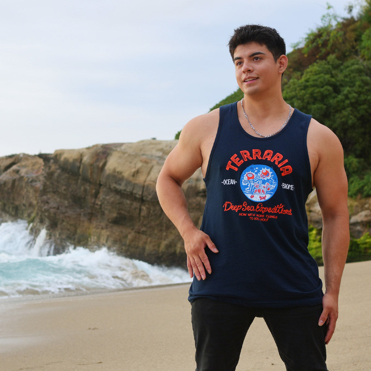 Lifestyle photo of model on the beach, wearing the Terraria Ocean Biome Tank Top