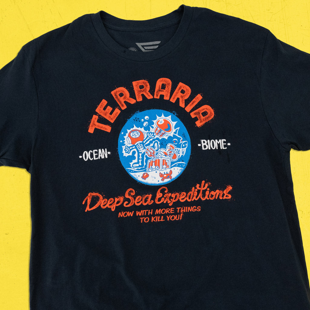 Flatlay of the Terraria Ocean Biome T-Shirt showing full front artwork inspired by the game’s coastal biome