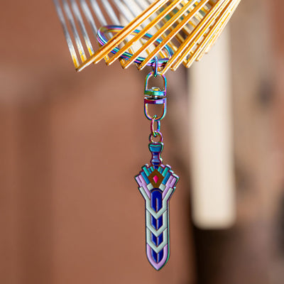 Photograph of the Terraria Zenith keychain hanging from a gold clasp.