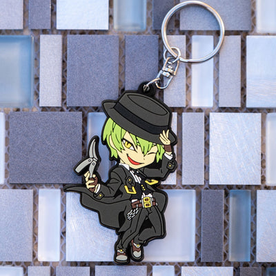 Image featuring the Hazama keychain, a piece of Blazblue merchandise, with a background that is more in focus compared to previous images.